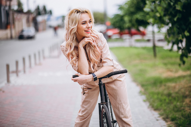 Woman on a bicycle with pink lips. 