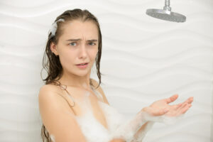 woman looking confused in the shower.
