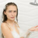 woman looking confused in the shower.