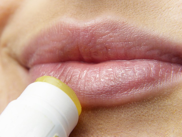 woman applying lip balm to her lips.