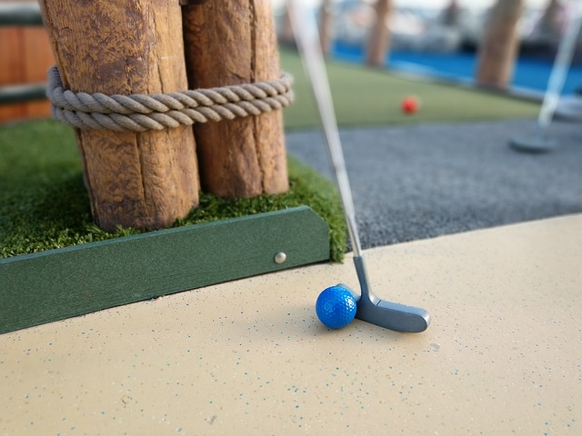 Two clubs at mini golf date.