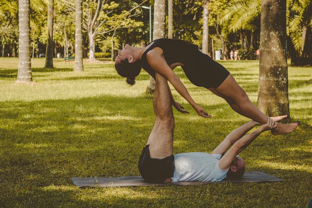 Couple workout out together in the park on a date. 