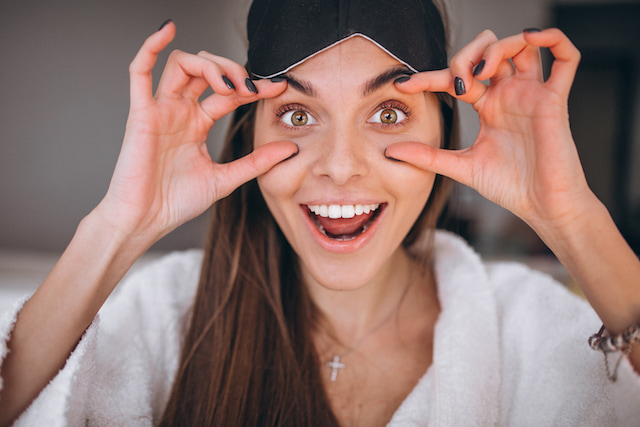 woman who is lifting her eyes to make them appear brighter.