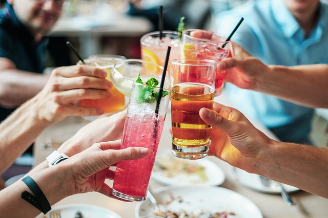 friends clinking alcohol glasses. 