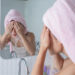 woman washing her face as skincare regime.
