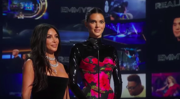 Kim Kardashian and Kendall Jenner looking not pleased while presenting during the Emmys.